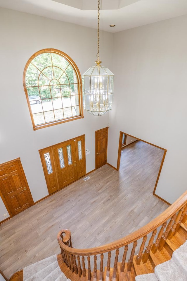 771 E Hickory Ave, Addison, IL 60101 - foyer featuring a chandelier, a high ceiling, stairs, and light wood-style flooring