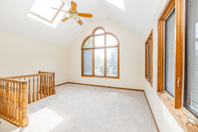 771 E Hickory Ave, Addison, IL 60101 - unfurnished room with a skylight, vaulted ceiling, ceiling fan, and carpet flooring