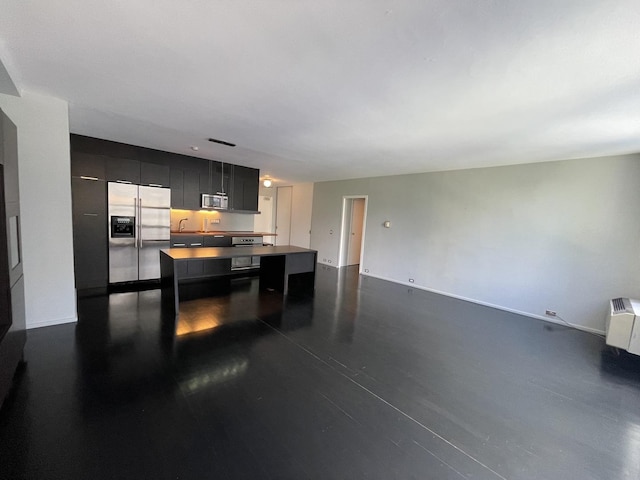 880 N Lake Shore Dr Unit 6F, Chicago, IL 60611 - kitchen featuring appliances with stainless steel finishes, dark cabinets, a kitchen island, dark wood-style flooring, and a breakfast bar area