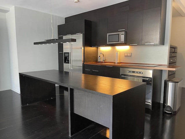 880 N Lake Shore Dr Unit 6F, Chicago, IL 60611 - kitchen with appliances with stainless steel finishes, dark cabinets, dark wood-style floors, dark countertops, and decorative backsplash