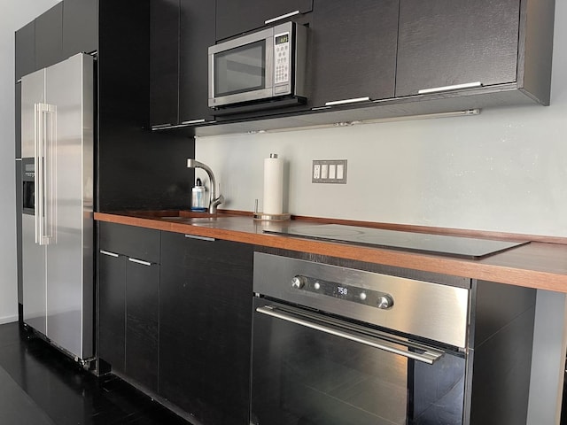 880 N Lake Shore Dr Unit 6F, Chicago, IL 60611 - kitchen featuring stainless steel appliances, dark cabinets, modern cabinets, and wood counters