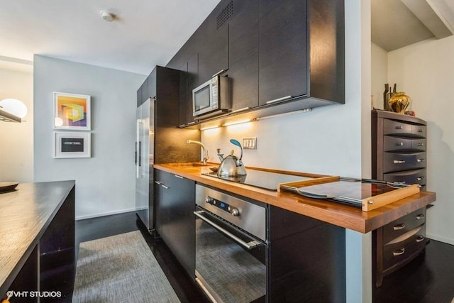 880 N Lake Shore Dr Unit 6F, Chicago, IL 60611 - kitchen featuring appliances with stainless steel finishes, wood counters, and dark cabinets
