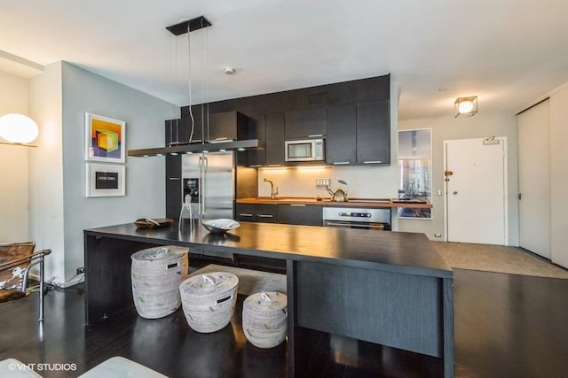 880 N Lake Shore Dr Unit 6F, Chicago, IL 60611 - kitchen featuring appliances with stainless steel finishes, dark cabinetry, and pendant lighting