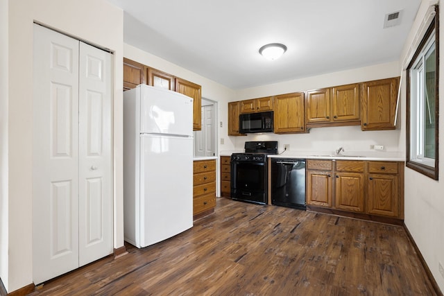 331 Regatta Point -, Schaumburg, IL 60194 - kitchen with black appliances, brown cabinetry, dark wood finished floors, and light countertops