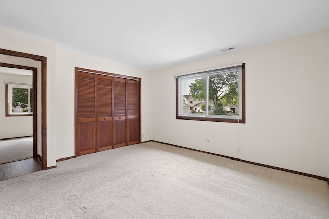 331 Regatta Point -, Schaumburg, IL 60194 - unfurnished bedroom featuring multiple windows, light carpet, and a closet