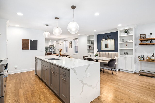 1726 W Huron St, Chicago, IL 60622 - kitchen featuring gray cabinetry, recessed lighting, light wood-style floors, light stone countertops, and a kitchen island with sink