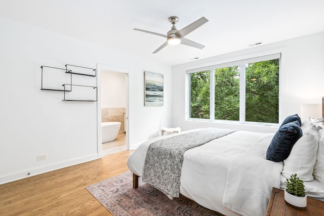 1726 W Huron St, Chicago, IL 60622 - bedroom with light wood-type flooring, ensuite bath, and a ceiling fan