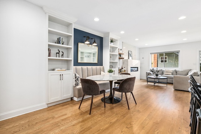 1726 W Huron St, Chicago, IL 60622 - dining area featuring light wood-style floors, recessed lighting, built in features, and a glass covered fireplace