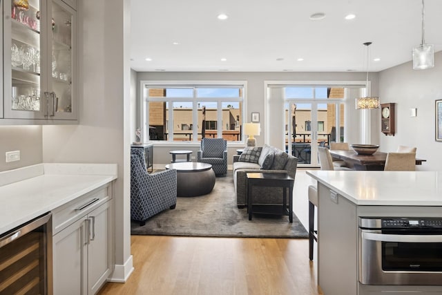 4115 N Lincoln Ave Unit 4N, Chicago, IL 60618 - kitchen featuring beverage cooler, light wood-style flooring, light countertops, healthy amount of natural light, and recessed lighting