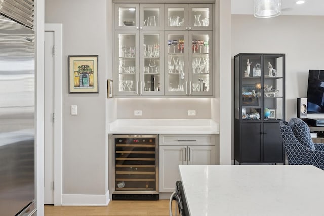 4115 N Lincoln Ave Unit 4N, Chicago, IL 60618 - bar featuring wine cooler, light wood-style floors, and stainless steel built in refrigerator