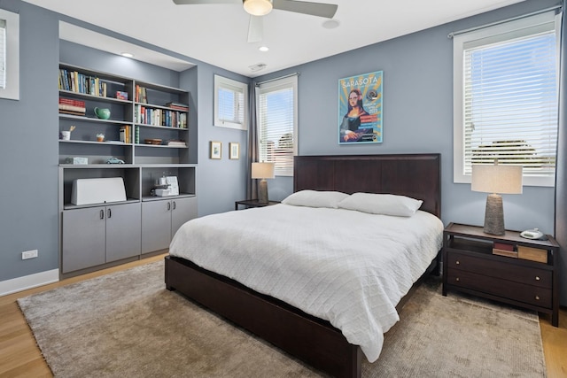 4115 N Lincoln Ave Unit 4N, Chicago, IL 60618 - bedroom with wood finished floors, multiple windows, and a ceiling fan