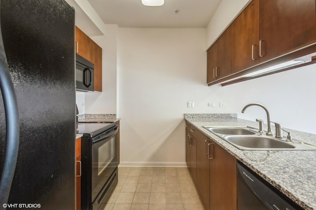 1720 Oak Ave Unit 407, Evanston, IL 60201 - kitchen with black appliances, light tile patterned floors, and light countertops