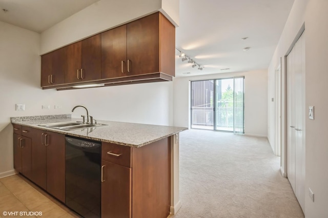 1720 Oak Ave Unit 407, Evanston, IL 60201 - kitchen featuring black dishwasher, light stone counters, light carpet, open floor plan, and track lighting