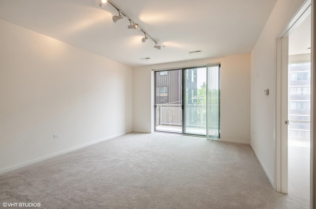 1720 Oak Ave Unit 407, Evanston, IL 60201 - spare room with track lighting and light colored carpet
