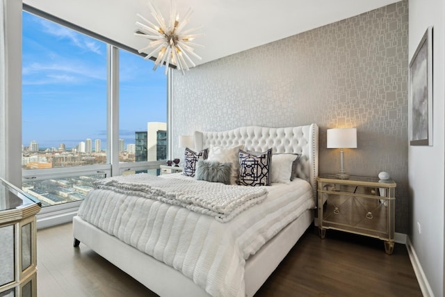 500 W Superior St Unit 1504, Chicago, IL 60654 - bedroom with a chandelier, a skyline view, wood finished floors, and a wall of windows
