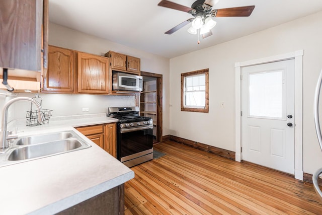 324 N 6th St, Dekalb, IL 60115 - kitchen with appliances with stainless steel finishes, light countertops, light wood-style flooring, and ceiling fan