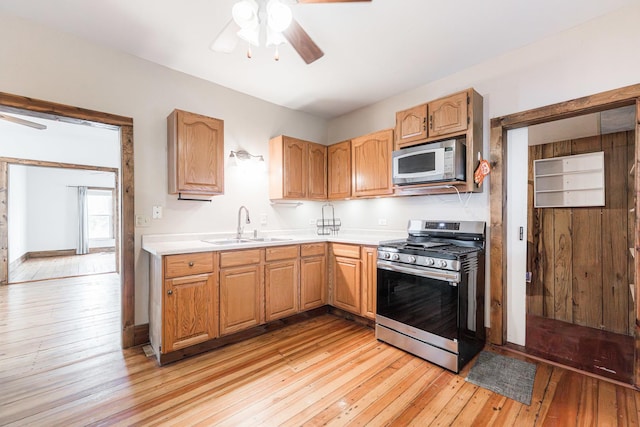 324 N 6th St, Dekalb, IL 60115 - kitchen with stainless steel gas stove, ceiling fan, light wood finished floors, and light countertops
