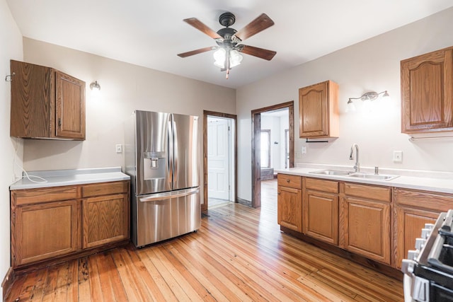 324 N 6th St, Dekalb, IL 60115 - kitchen with appliances with stainless steel finishes, a ceiling fan, light wood-style floors, light countertops, and brown cabinets