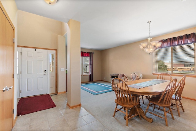 244 Prescott Ave, Elgin, IL 60124 - dining room featuring a chandelier, light tile patterned flooring, and light colored carpet