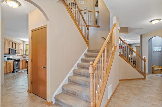 244 Prescott Ave, Elgin, IL 60124 - stairway featuring arched walkways and tile patterned flooring
