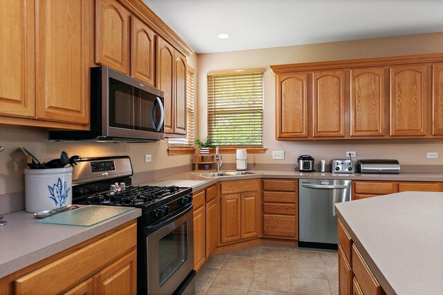 244 Prescott Ave, Elgin, IL 60124 - kitchen featuring stainless steel appliances, light countertops, light tile patterned flooring, and recessed lighting