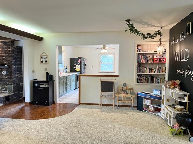 1413 Eustace Dr, Dixon, IL 61021 - living area with a ceiling fan and carpet flooring