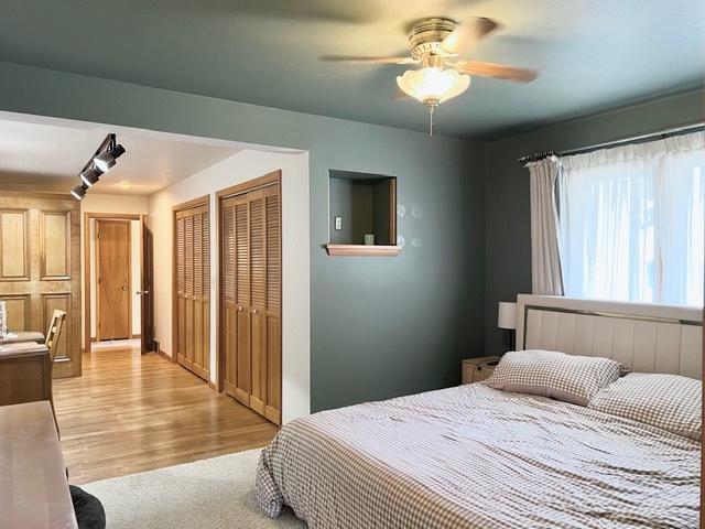 1413 Eustace Dr, Dixon, IL 61021 - bedroom with two closets, light wood-type flooring, and ceiling fan
