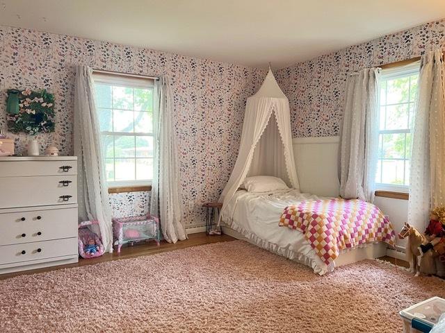 1413 Eustace Dr, Dixon, IL 61021 - bedroom with wallpapered walls, multiple windows, and wood finished floors