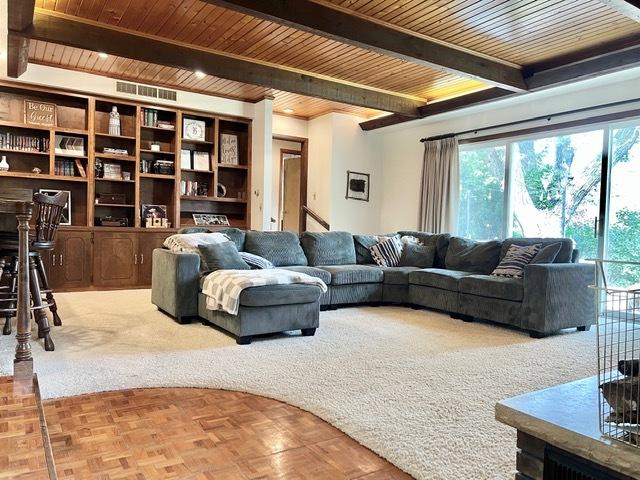 1413 Eustace Dr, Dixon, IL 61021 - living area featuring plenty of natural light and a wood ceiling with exposed beams
