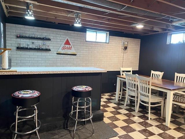 1413 Eustace Dr, Dixon, IL 61021 - indoor bar with tile patterned floors and brick wall