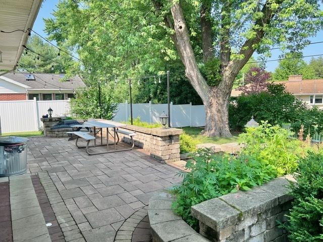 1413 Eustace Dr, Dixon, IL 61021 - fenced backyard featuring a patio area and outdoor dining space