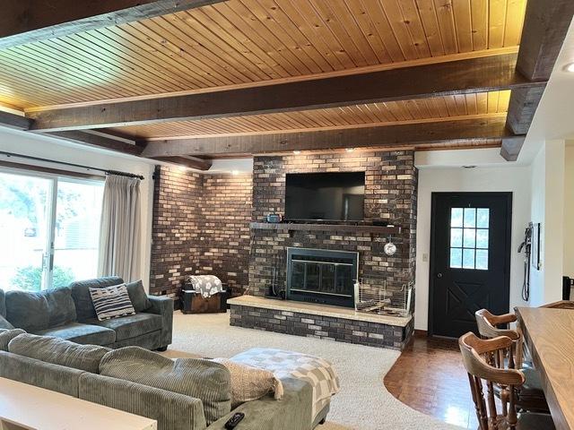 1413 Eustace Dr, Dixon, IL 61021 - living room featuring a wooden ceiling with exposed beams, healthy amount of natural light, and a fireplace