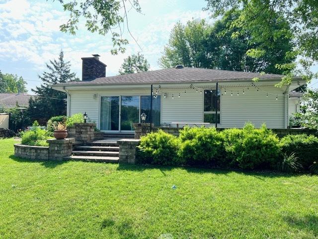 1413 Eustace Dr, Dixon, IL 61021 - rear view of property with a chimney and a yard