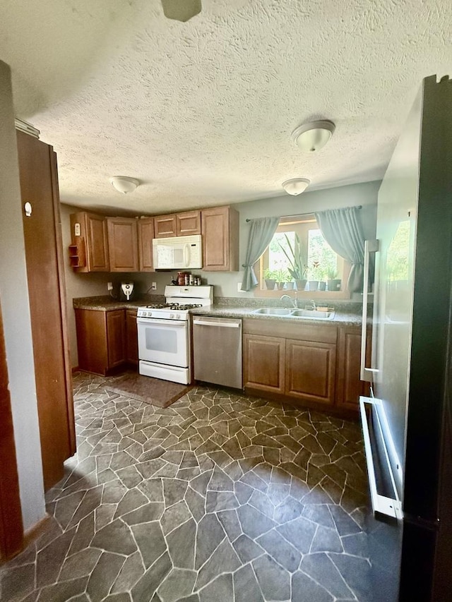 106 E Poplar St, Normal, IL 61761 - kitchen featuring stainless steel appliances, dark stone finish flooring, and a textured ceiling