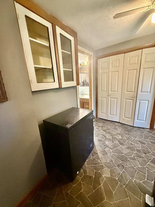 106 E Poplar St, Normal, IL 61761 - unfurnished office featuring stone floors, a textured ceiling, and a ceiling fan