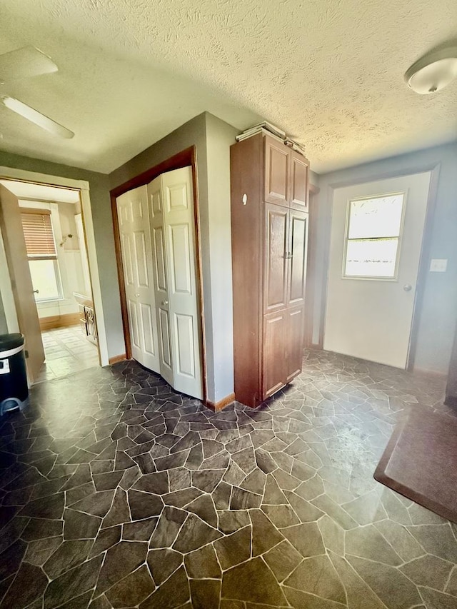 106 E Poplar St, Normal, IL 61761 - hallway featuring stone flooring and a textured ceiling