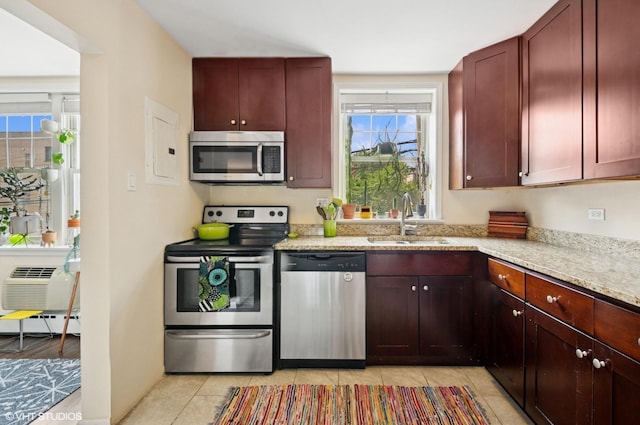 2427 W Farragut Ave Unit 1A, Chicago, IL 60625 - kitchen with appliances with stainless steel finishes, reddish brown cabinets, light stone countertops, and light tile patterned flooring