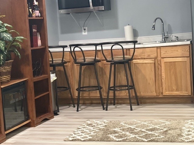 5302 Foxwood Ct, Plainfield, IL 60586 - bar area featuring light wood-type flooring and stainless steel microwave