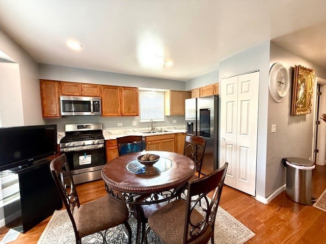 5302 Foxwood Ct, Plainfield, IL 60586 - kitchen featuring appliances with stainless steel finishes, light countertops, light wood-type flooring, and brown cabinetry