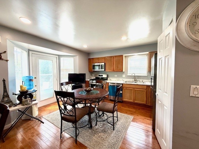 5302 Foxwood Ct, Plainfield, IL 60586 - kitchen with appliances with stainless steel finishes, light countertops, wood finished floors, brown cabinets, and recessed lighting
