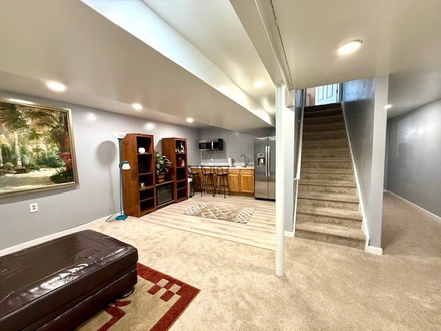 5302 Foxwood Ct, Plainfield, IL 60586 - living area featuring light colored carpet, stairs, and recessed lighting