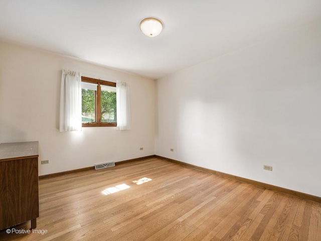 628 W 15th St, Chicago Heights, IL 60411 - spare room featuring wood finished floors and baseboards