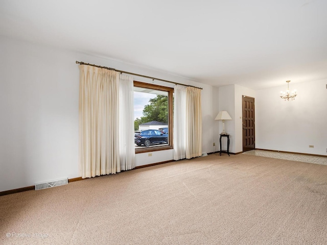 628 W 15th St, Chicago Heights, IL 60411 - unfurnished room featuring a chandelier and light colored carpet