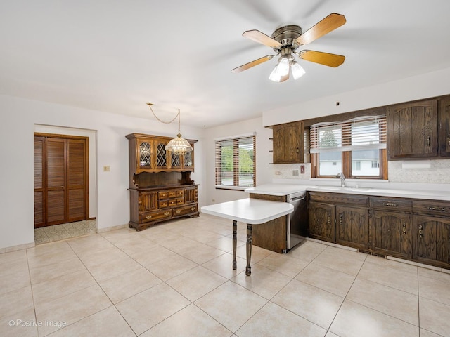 628 W 15th St, Chicago Heights, IL 60411 - kitchen with dishwasher, light countertops, dark brown cabinetry, and backsplash