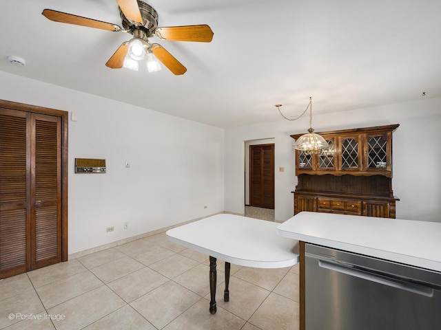 628 W 15th St, Chicago Heights, IL 60411 - kitchen featuring stainless steel dishwasher, light tile patterned floors, light countertops, ceiling fan, and decorative light fixtures