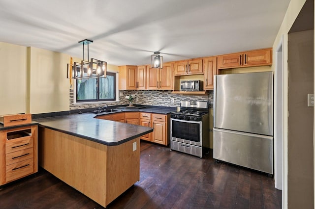 924 E 159th Pl, South Holland, IL 60473 - kitchen with stainless steel appliances, dark countertops, a peninsula, tasteful backsplash, and dark wood finished floors