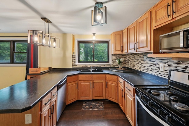 924 E 159th Pl, South Holland, IL 60473 - kitchen featuring appliances with stainless steel finishes, a peninsula, dark countertops, and decorative backsplash