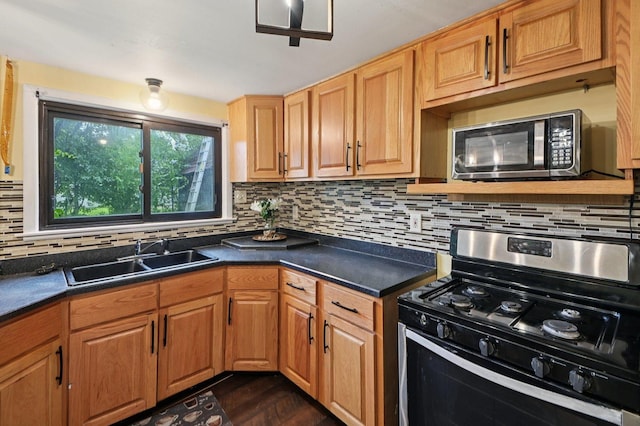 924 E 159th Pl, South Holland, IL 60473 - kitchen with appliances with stainless steel finishes, backsplash, dark countertops, and dark wood-type flooring