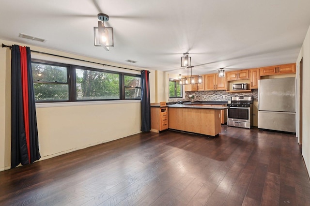 924 E 159th Pl, South Holland, IL 60473 - kitchen with stainless steel appliances, dark countertops, decorative backsplash, and dark wood finished floors