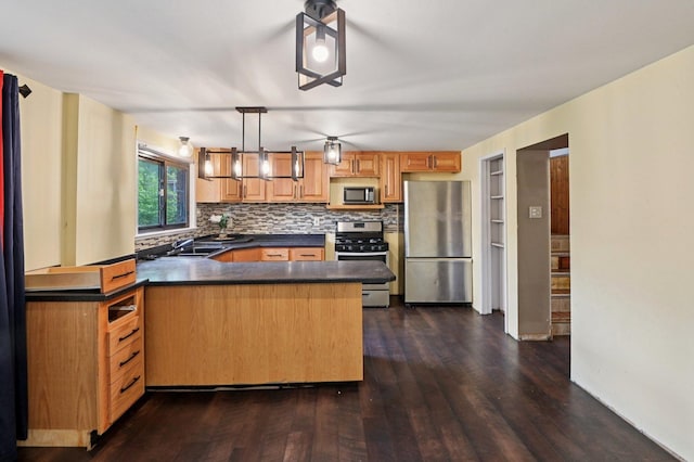 924 E 159th Pl, South Holland, IL 60473 - kitchen with stainless steel appliances, dark countertops, a peninsula, dark wood-type flooring, and backsplash